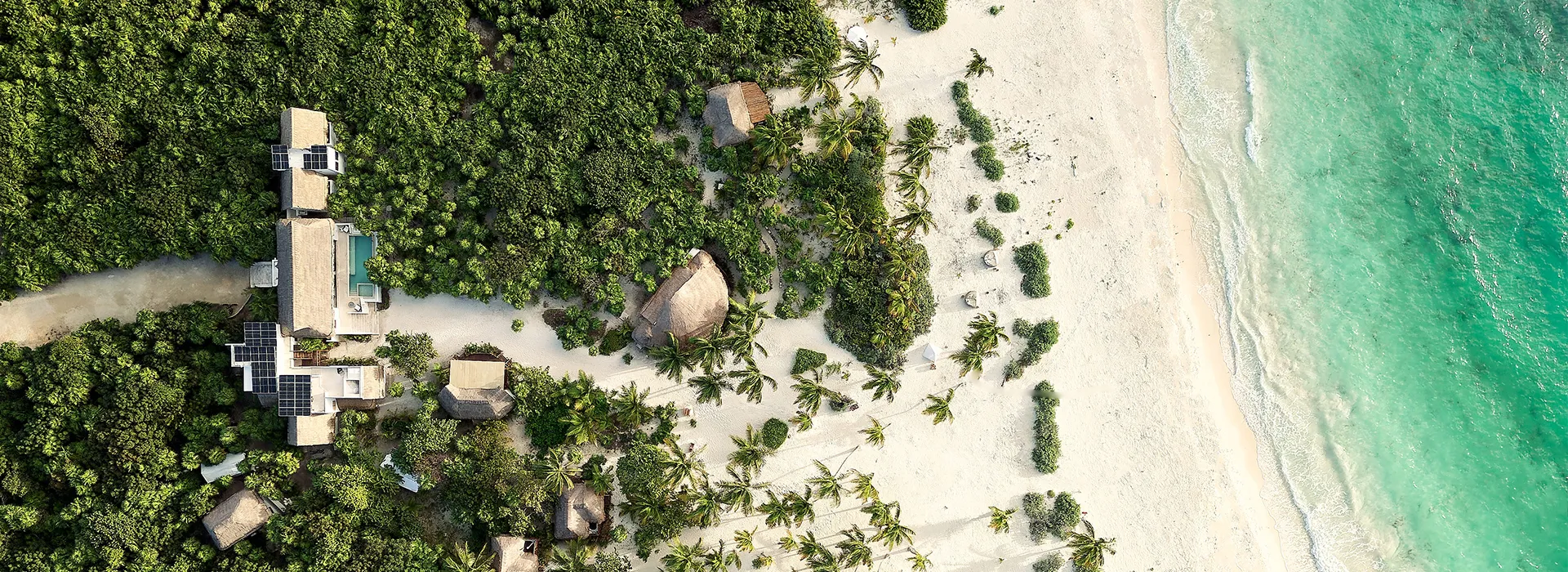 An aerial view of a beach with a house in the middle of it, a tilt shift photo by Hugo Heyrman, trending on unsplash, primitivism, uhd image, playstation 5 screenshot, photo taken with ektachrome