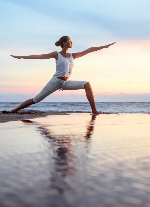 a woman doing a yoga pose on the beach, a stock photo by Thota Vaikuntham, shutterstock contest winner, arabesque, dynamic pose, stock photo, dynamic composition